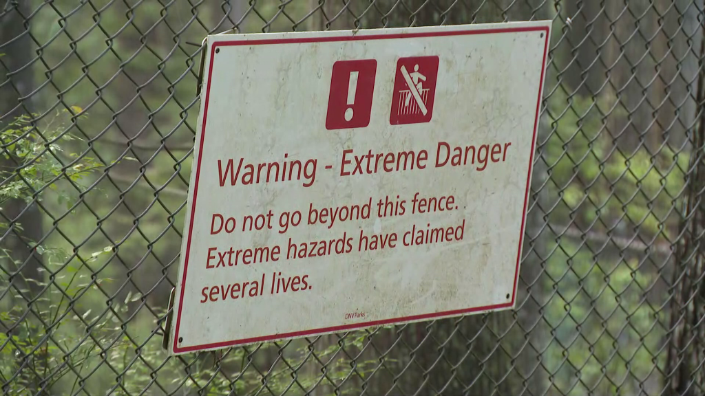 A fence with a warning sign is seen in Lynn Canyon Park in North Vancouver on Monday August 26, 2024.