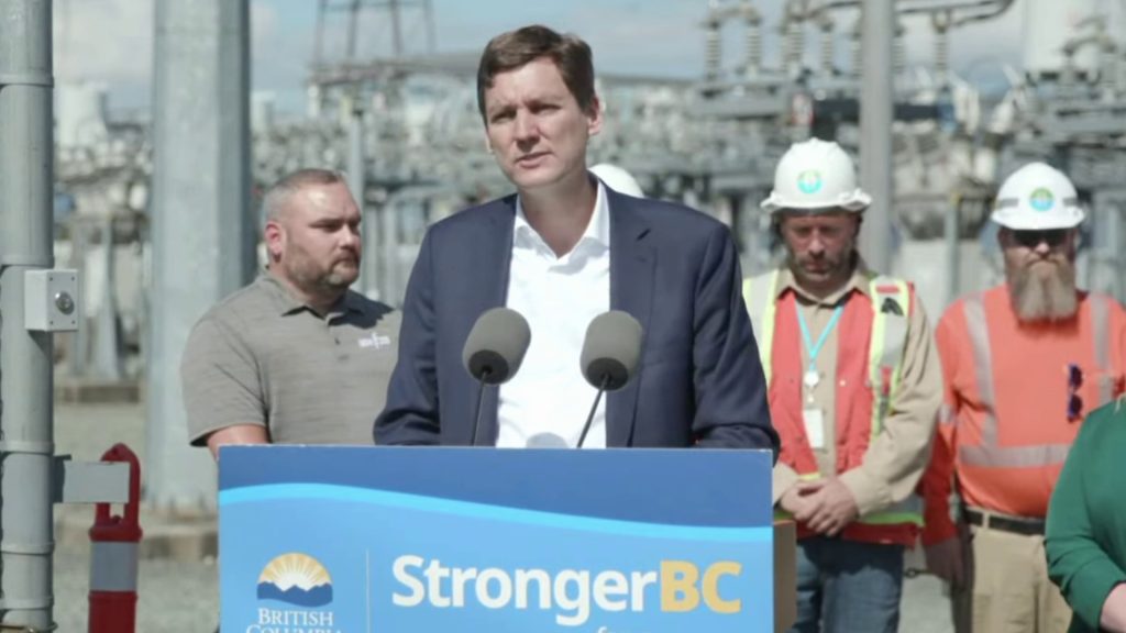 David Eby speaking at a podium