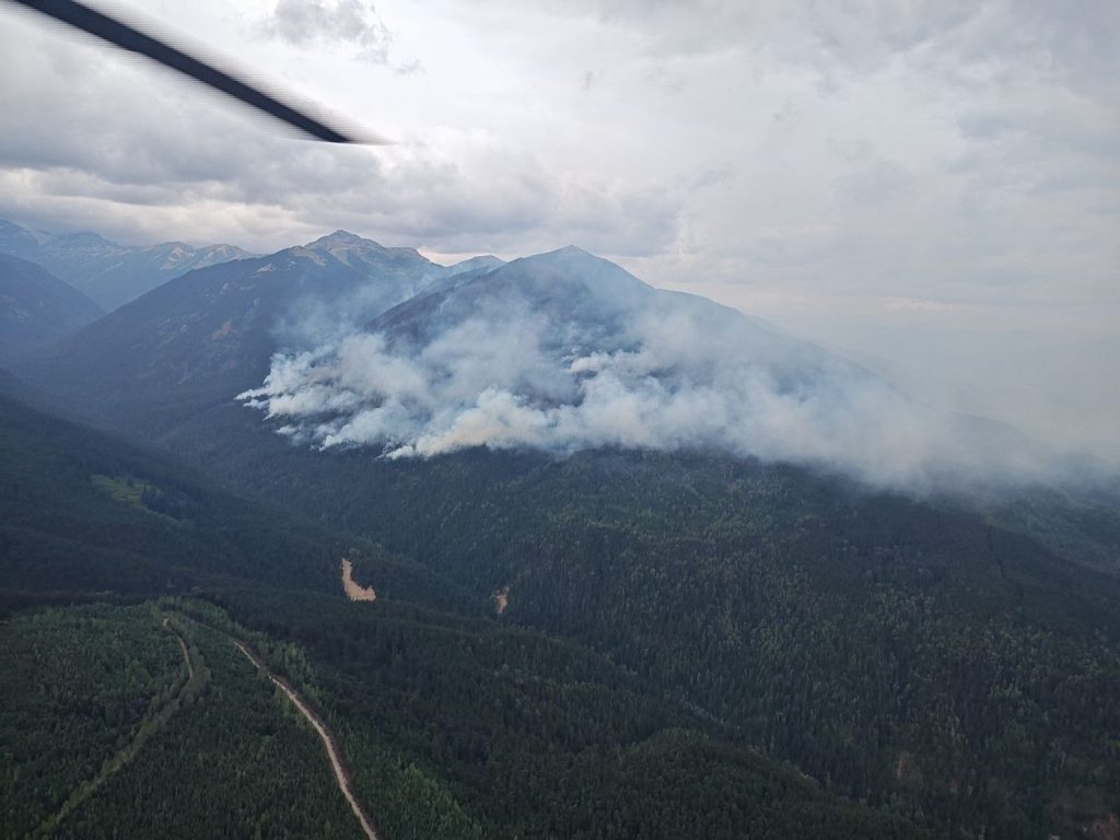 Rain and cool weather in southern British Columbia is dousing wildfire activity in the province, but firefighters are urging vigilance despite the drop in the number of active blazes. A view of the Corya Creek wildfire is seen near Witset, B.C., in an Aug. 19, 2024, handout photo.