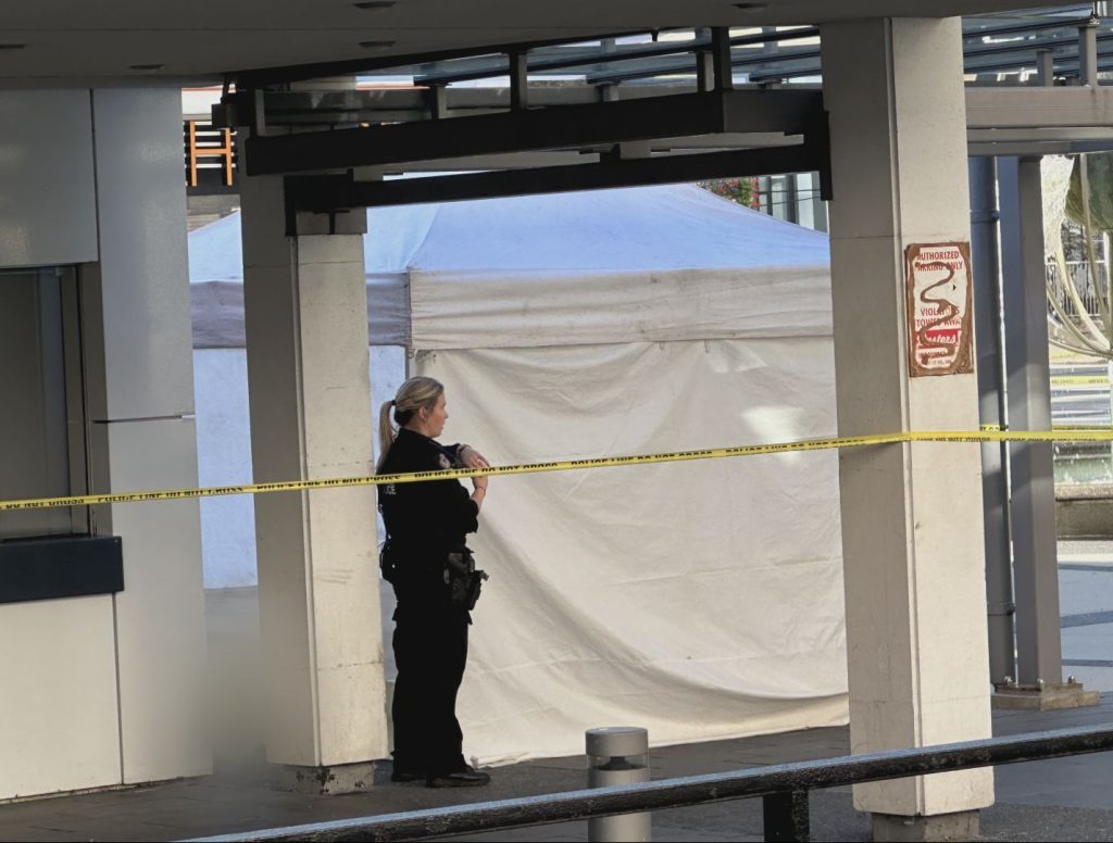 Police tape was set up Sept. 4, 2024, blocking off a portion of the Queen Elizabeth Theatre plaza, near the box office. A white tent was also set up, covering what looks to be a body. A pool of blood can be seen nearby on the sidewalk. (CityNews Image / Mike Lloyd)