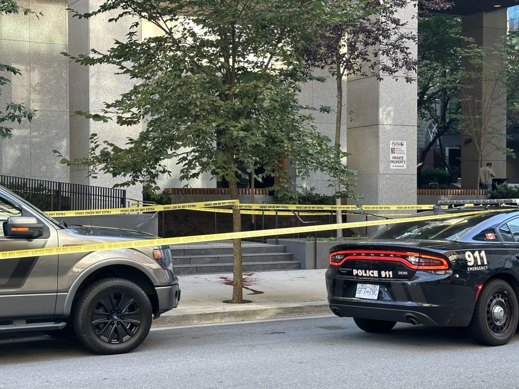 Police tape was set up Sept. 4, 2024, blocking off a portion of the Queen Elizabeth Theatre plaza, near the box office. A white tent was also set up, covering what looks to be a body. A pool of blood can be seen nearby on the sidewalk. (CityNews Image / Mike Lloyd)