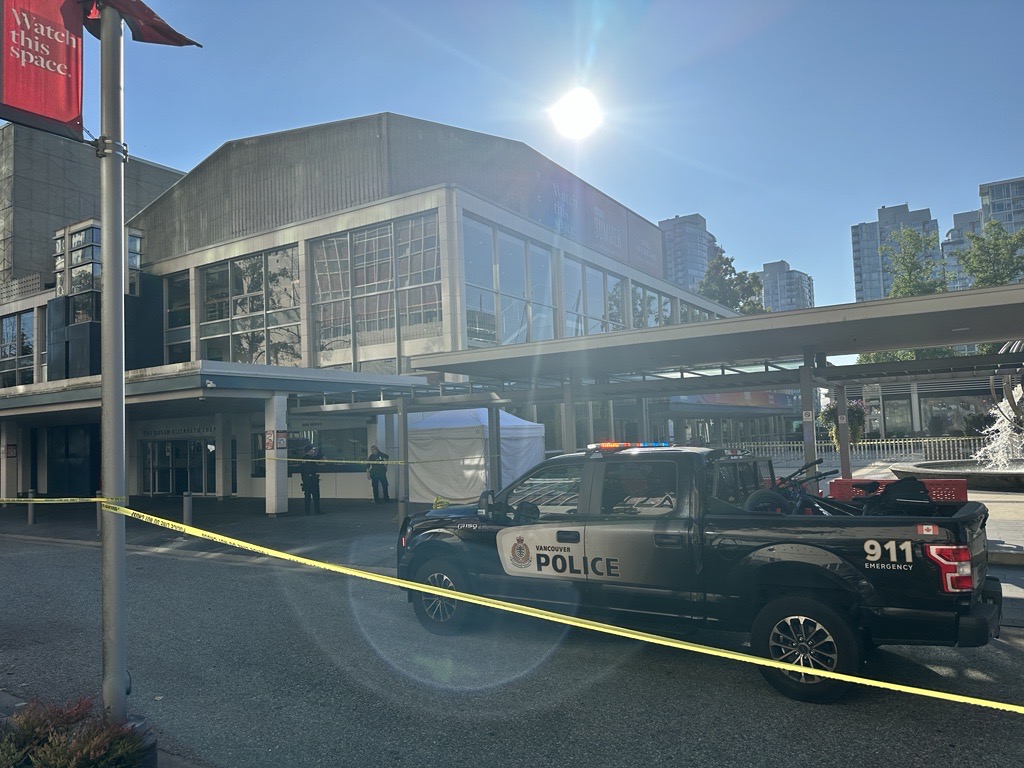 Police tape was set up Sept. 4, 2024, blocking off a portion of the Queen Elizabeth Theatre plaza, near the box office. A white tent was also set up, covering what looks to be a body. A pool of blood can be seen nearby on the sidewalk. (CityNews Image / Mike Lloyd)