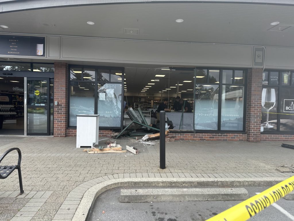 Remnants of a vehicle crash through a BC Liquor Store location window