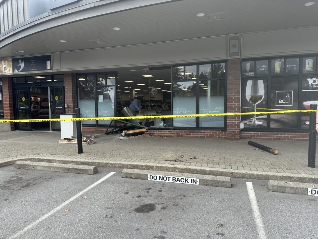 Remnants of a vehicle crash through a BC Liquor Store location window