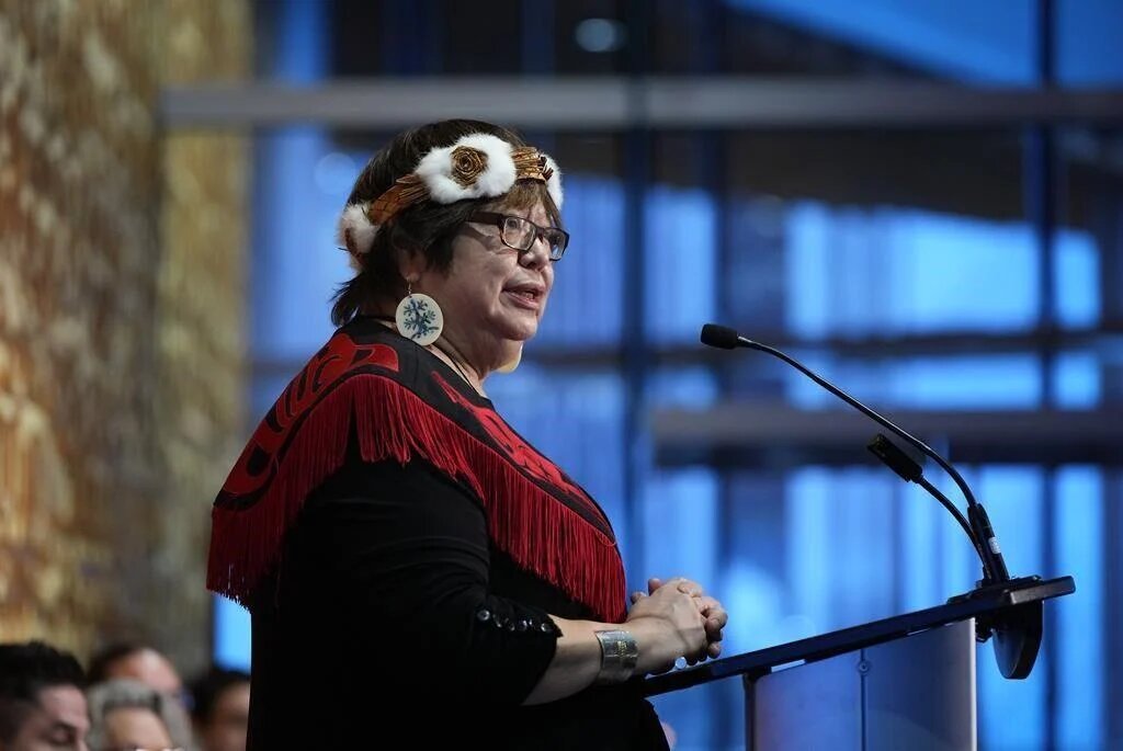 Judith Sayers speaks at a podium