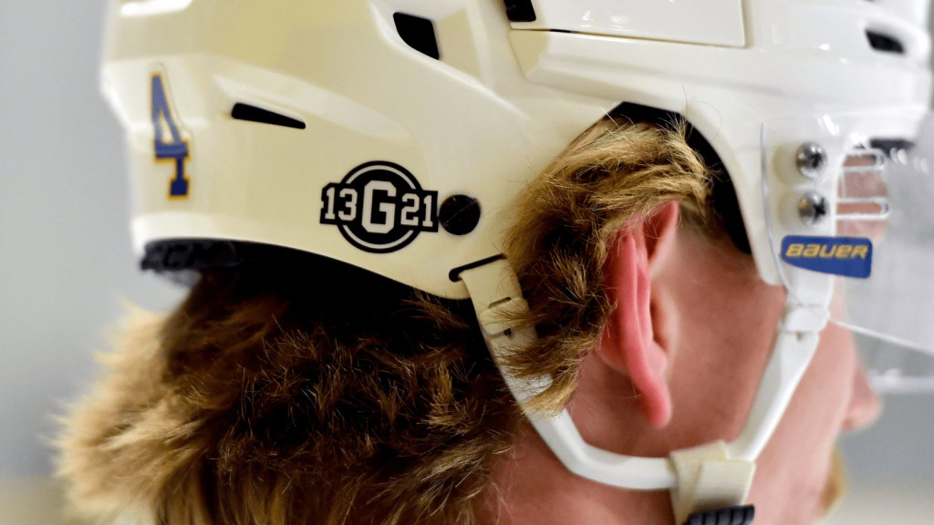 The back of a hockey helmet showing a decal that reads 13 G 21