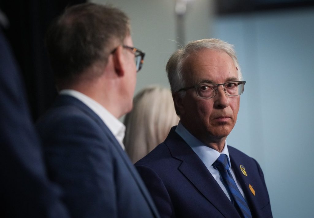 BC Conservative Leader John Rustad, right, pauses to confer with BC United Leader Kevin Falcon while responding to questions during a news conference, in Vancouver, on Wednesday, Aug. 28, 2024. A series of candidates for British Columbia's upcoming provincial election have disappeared off the B.C. Conservative's website with some BC United nominees taking their place. THE CANADIAN PRESS/Darryl Dyck