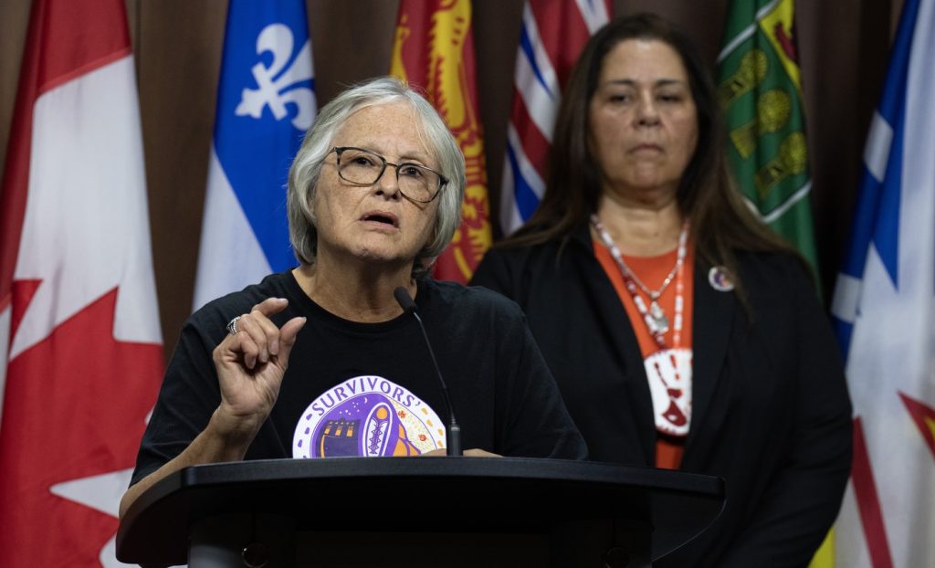 The Survivors' Secretariat Executive Lead Laura Arndt, right, looks on as survivor of the Mohawk Institute and Secretariat board member Roberta Hill speaks during a news conference on Parliament Hill, in Ottawa, Monday, Sept. 30, 2024.