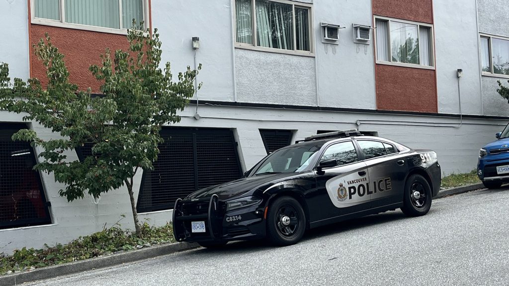 Vancouver Police stationed outside a building near Kingsway and Melbourne Street on Thursday October 3, 2024.