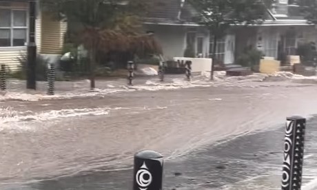 Water flowing down a street in Deep Cove during an atmospheric river Oct. 19, 2024.