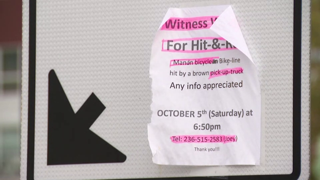 A sign asking for witnesses is seen near Gilbert Rd crossing the intersection of River Rd on Tuesday, October 29, 2024.