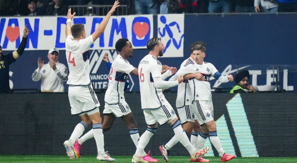 Vancouver Whitecaps' Ranko Veselinovic, from left to right, Ali Ahmed, Tristan Blackmon, Ryan Gauld and Sebastian Berhalter, back right, celebrate Gauld's goal against Los Angeles FC during the first half of a first-round MLS Cup playoffs soccer match, in Vancouver, on Sunday, November 3, 2024. (Darryl Dyck/CP)