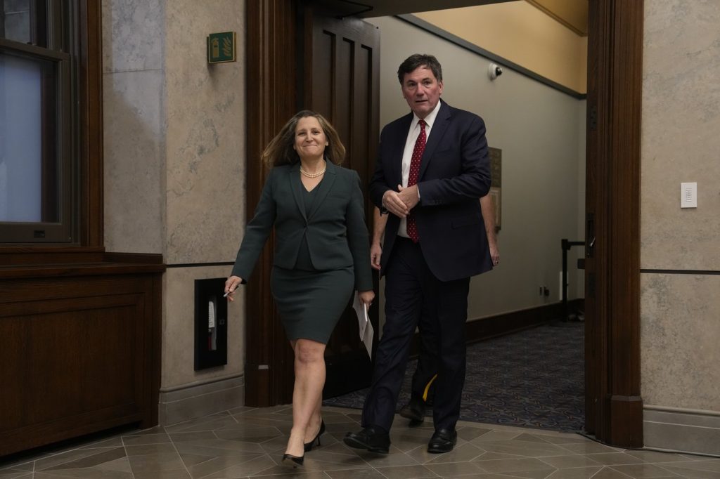 Then Finance Minister Chrystia Freeland Minister of Public Safety Dominic LeBlanc
make their way to speak with reporters, Wednesday, Nov. 27, 2024. THE CANADIAN PRESS/Adrian Wyld 