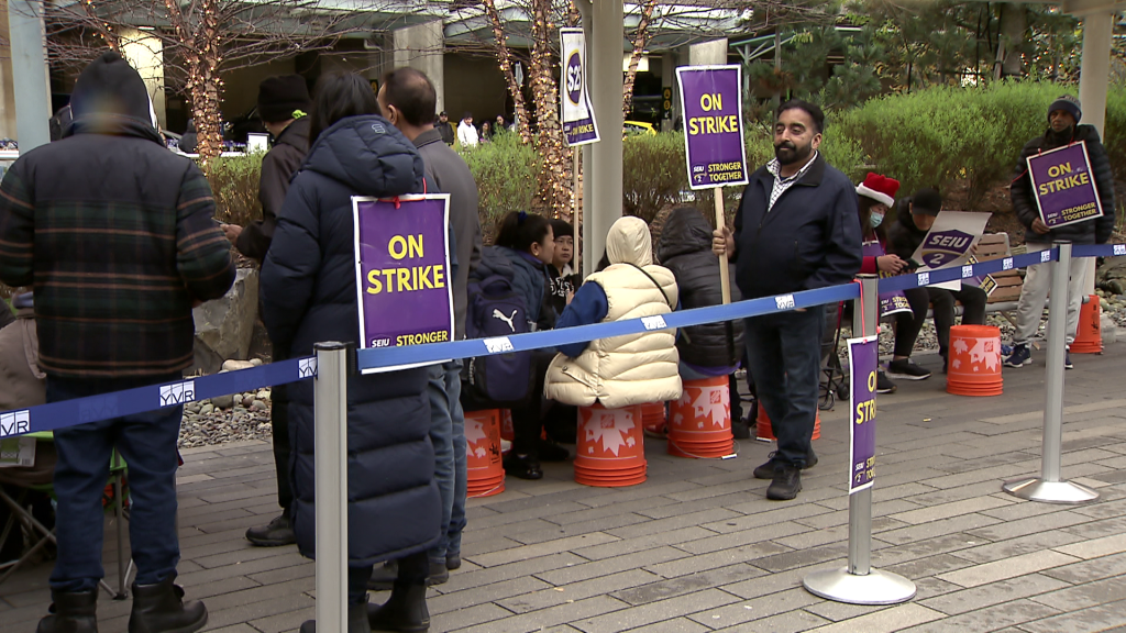 SEIU 2 Local union members demonstrate at Vancouver International Airport in Richmond, B.C. on Monday December 23, 2024.