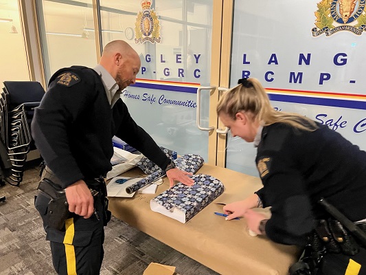 Langley RCMP officers wrapping gifts