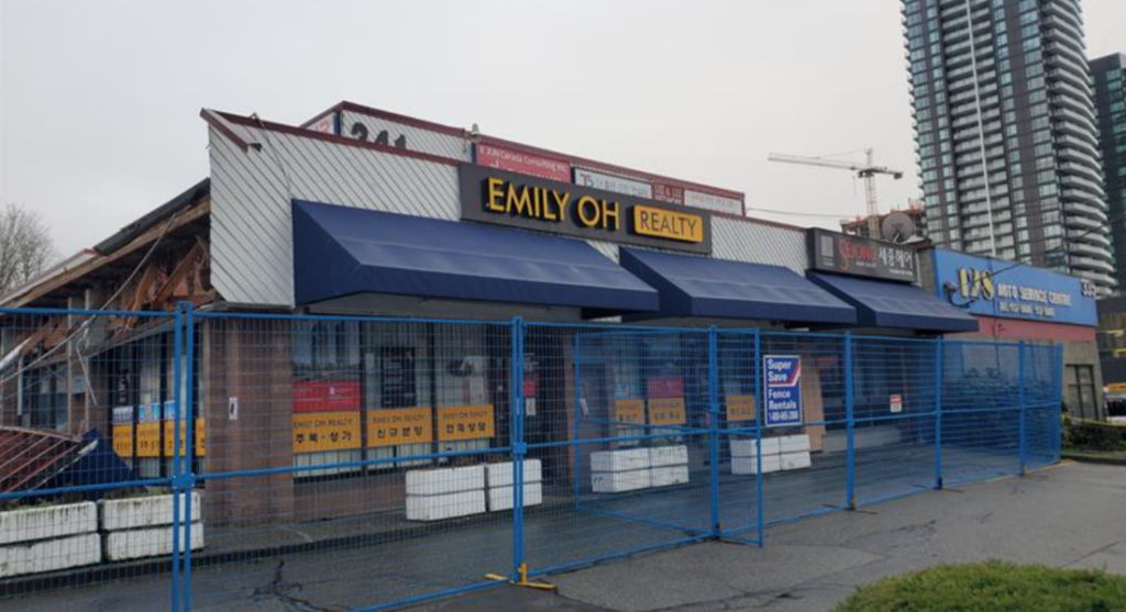 A Coquitlam strip mall remains fenced off on Jan. 5, 2025, a week after a destructive fire.