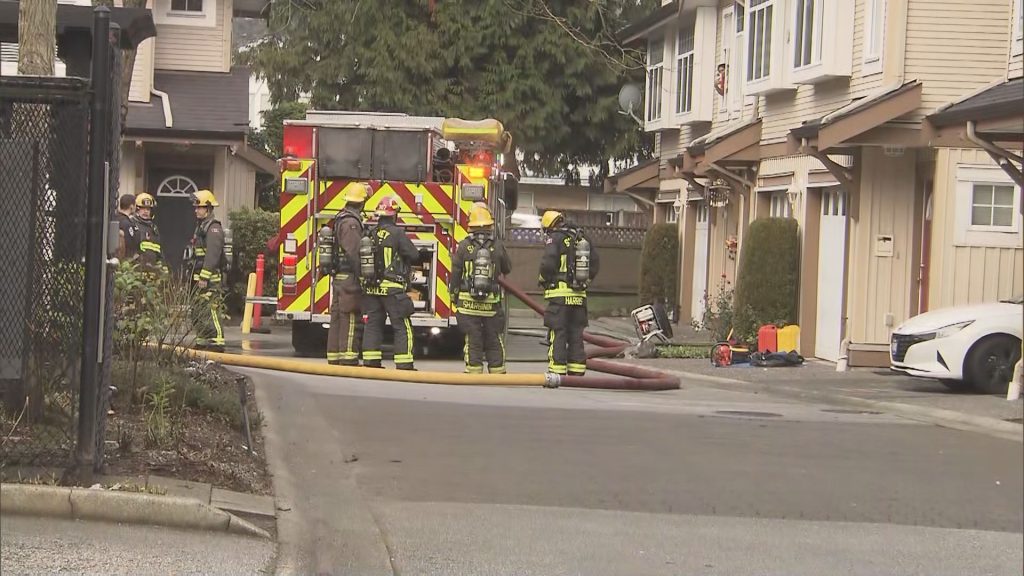 Firefighters approach a fire engine