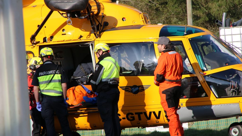 North Shore Rescue crews land a helicopter with an inured hiker