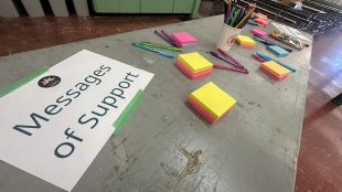 A table of post-it notes encourages writing messaging of support