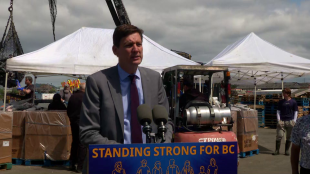 David Eby speaking at a podium