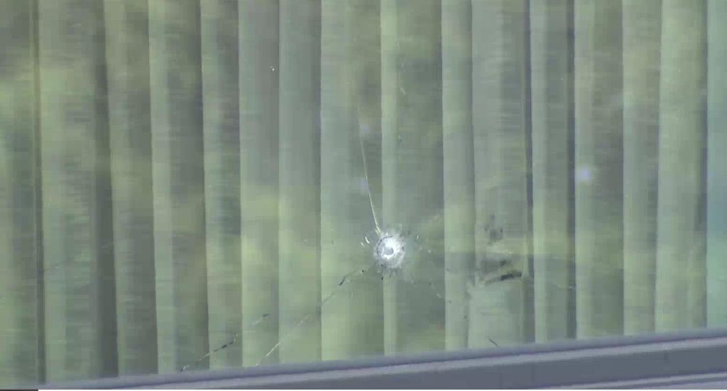 Bullet holes are seen on a window