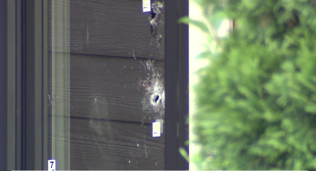 Bullet holes are seen on a window