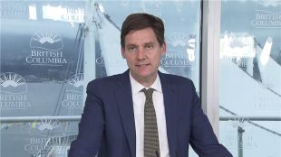David Eby speaking at a podium