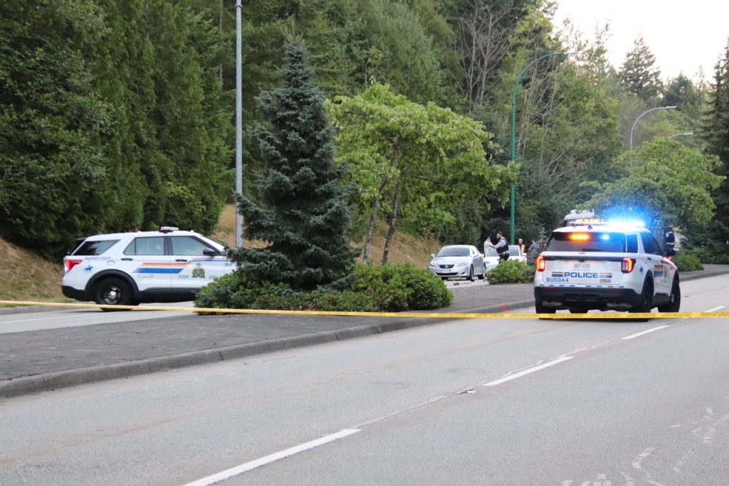 Photos from the Burnaby Mountain crash scene show a badly damaged vehicle, with debris strewn across the roadway. (Credit: 1st Due Media)