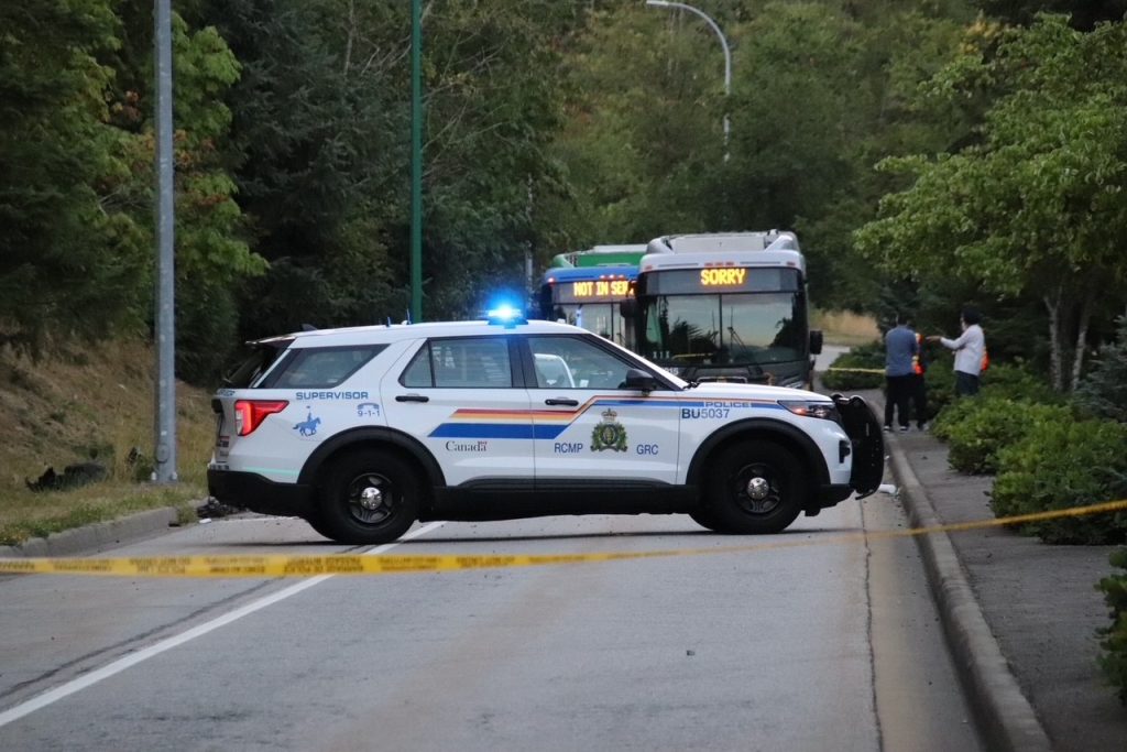 Photos from the Burnaby Mountain crash scene show a badly damaged vehicle, with debris strewn across the roadway. (Credit: 1st Due Media)