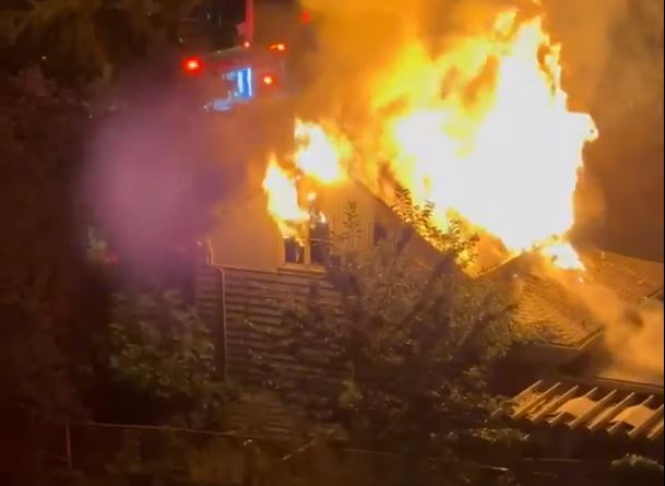 Flames issue from a structure fire