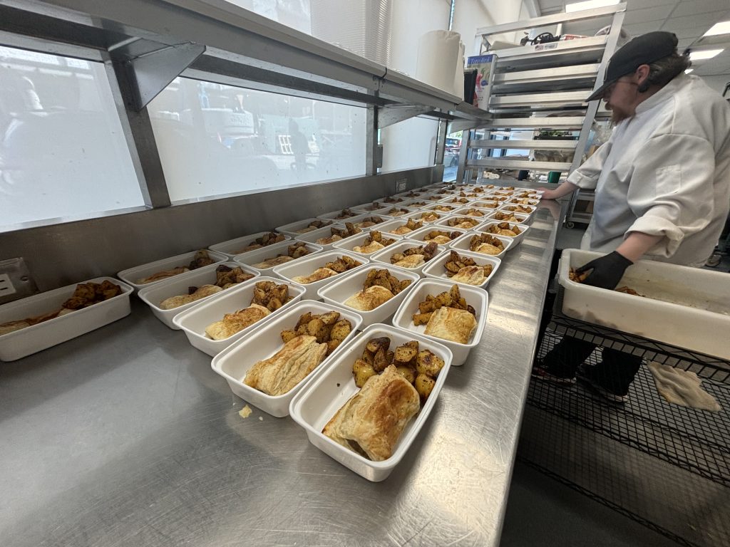 Food is being prepared in the kitchen of the Potluck Cafe Society.