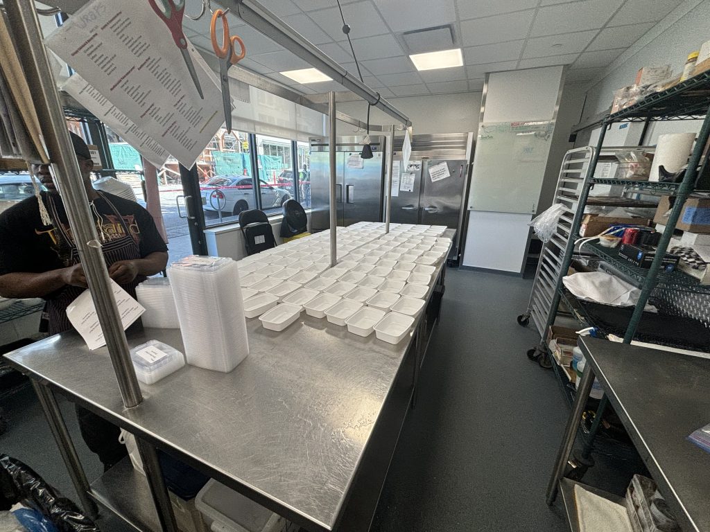 Food is being prepared in the kitchen of the Potluck Cafe Society.