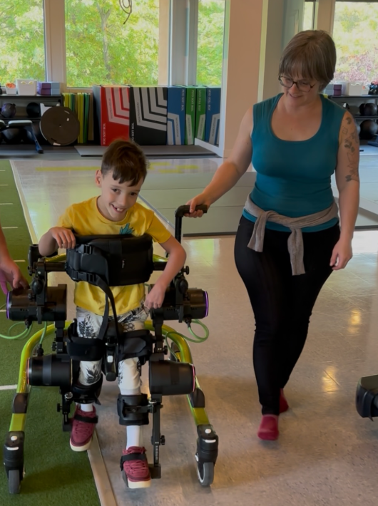 Eight-year-old Elliot and his mother, Genevieve Parent. A new device has allowed Elliot to take his first steps.
