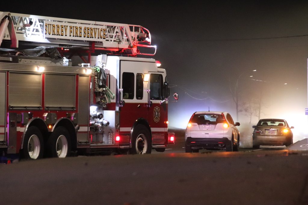 Emergency crews in Surrey investigate a collision between the driver of a vehicle and a pedestrian