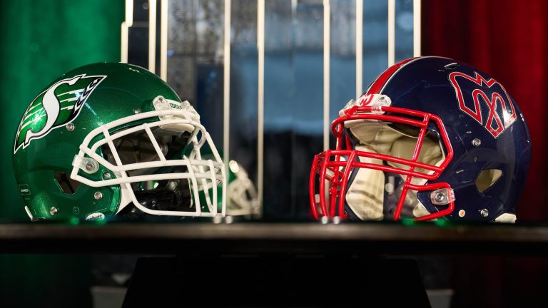 Saskatchewan Roughriders and Montreal Alouettes helmets in front of the Grey Cup during the Grey Cup head coaches' media conference in Winnipeg, Tuesday, Nov. 11, 2025. The Alouettes and Roughriders are set to to play the 112th Grey Cup on Nov. 16. THE CANADIAN PRESS/David Lipnowski