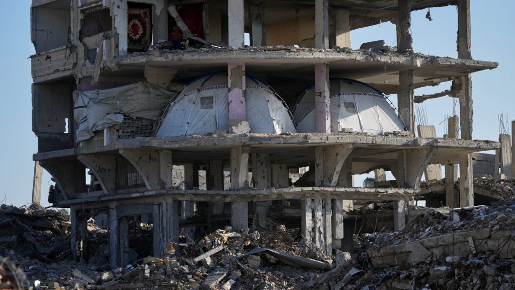 Tents are set up inside a gutted apartment building in Khan Younis, in the southern Gaza Strip, Saturday, Nov. 15, 2025. (AP Photo/Abdel Kareem Hana)