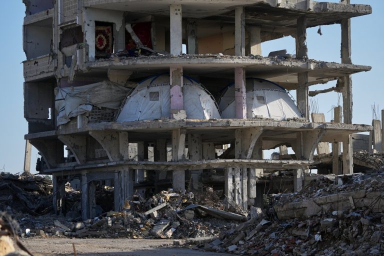 Tents are set up inside a gutted apartment building in Khan Younis, in the southern Gaza Strip, Saturday, Nov. 15, 2025. (AP Photo/Abdel Kareem Hana) 