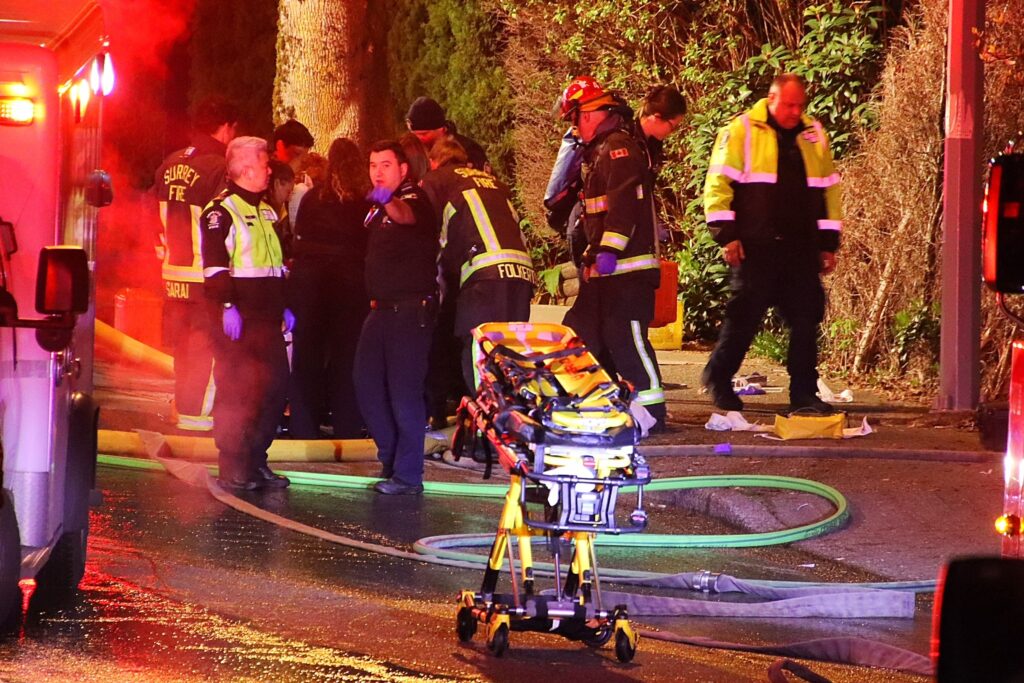 Emergency crews surround a house in Surrey after a fire