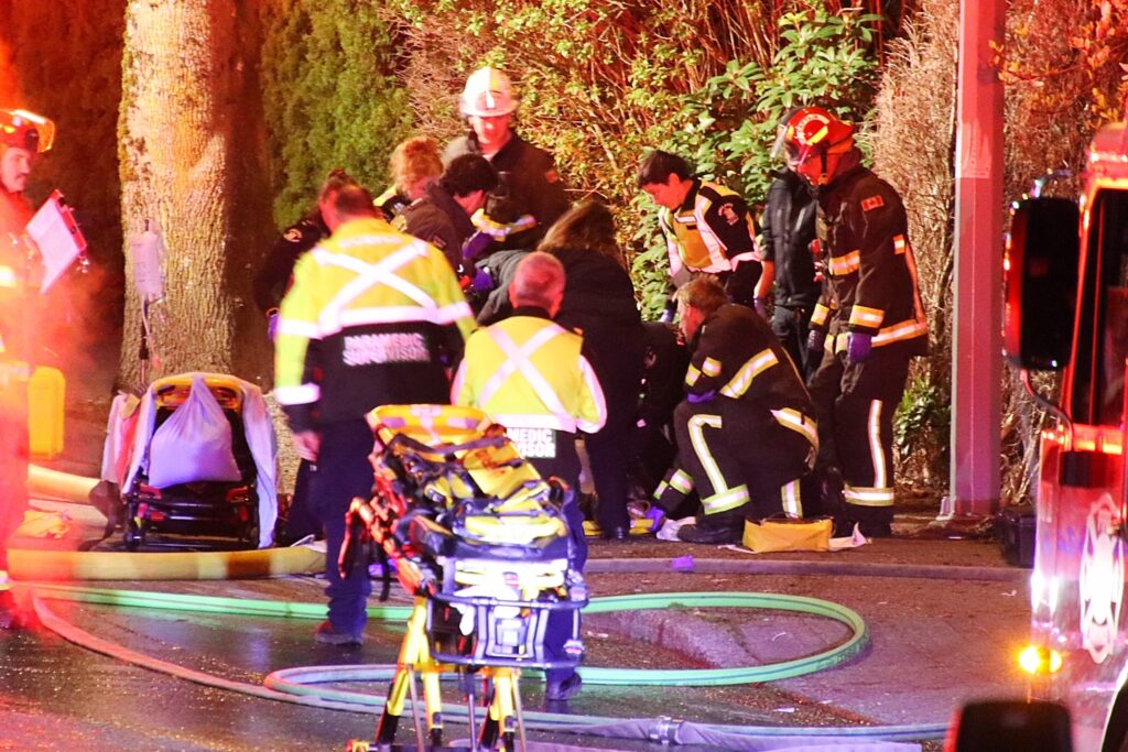 Emergency crews surround a house in Surrey after a fire