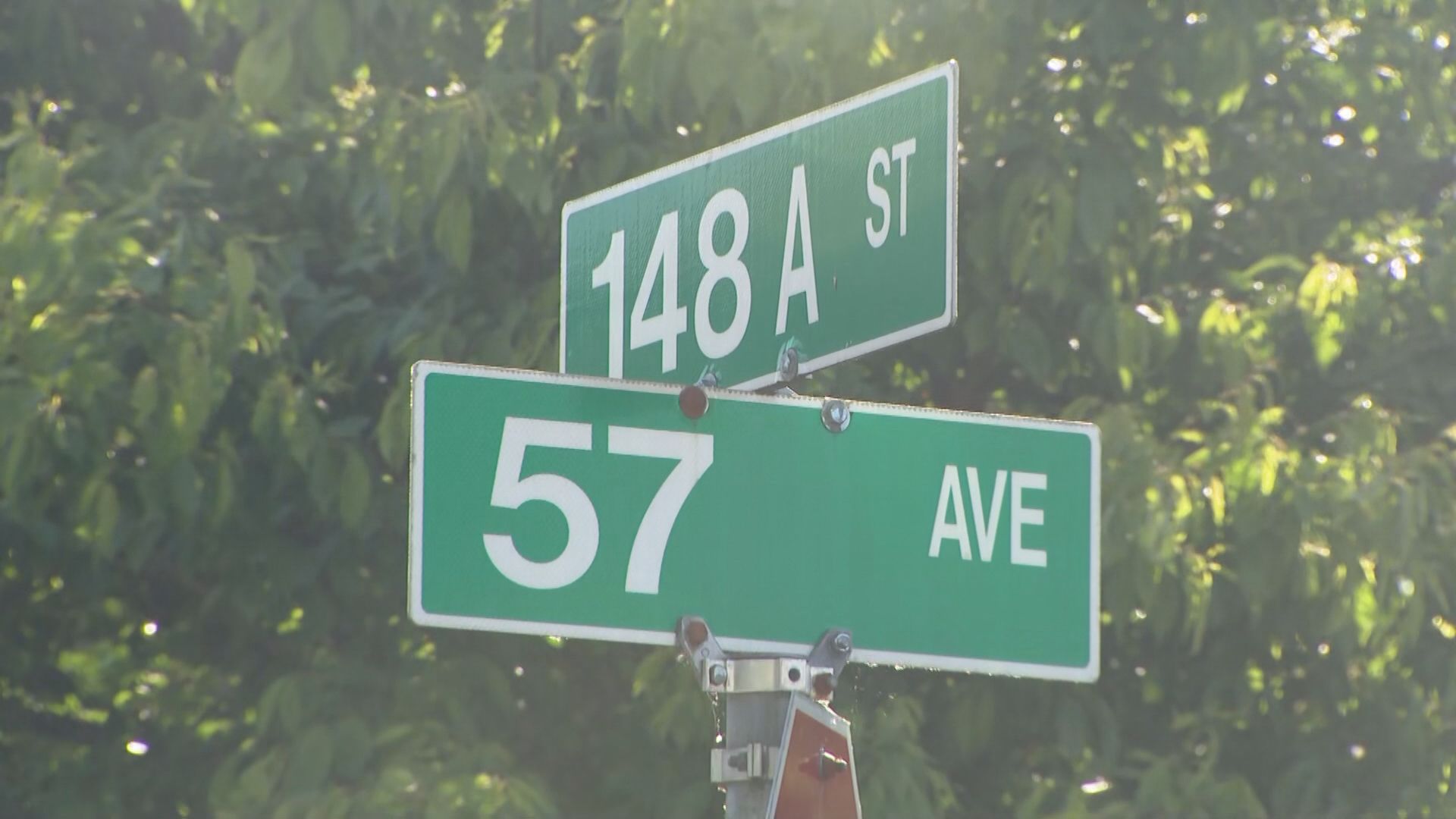 A sign indicating the intersection of 148A street and 57 Avenue in Surrey